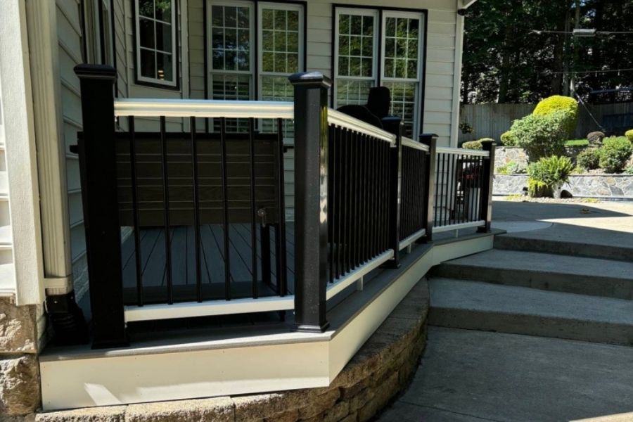 Composite deck with aluminum railing and stone base